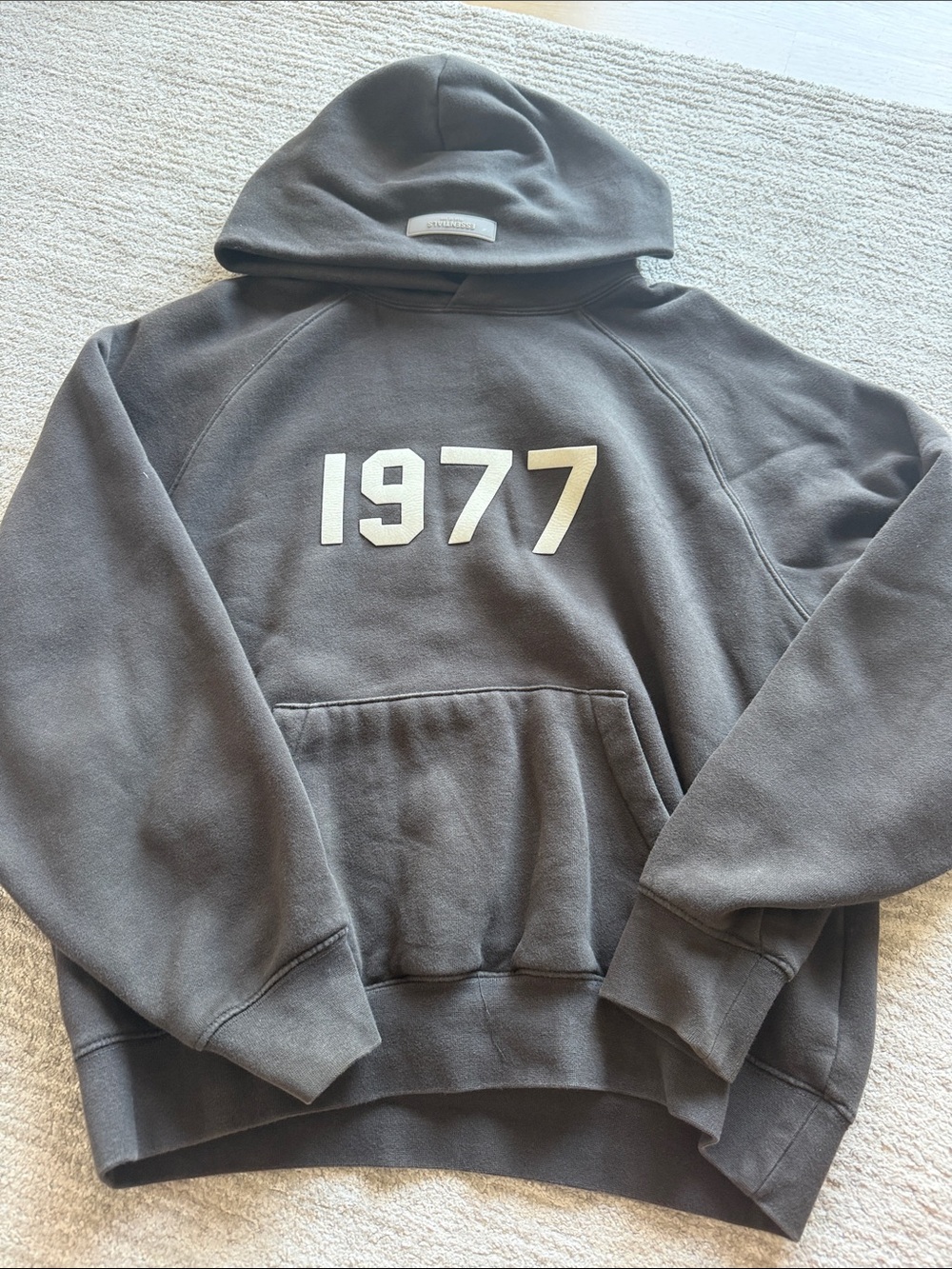 ESSENTIALS Hoodie in Charcoal with Cream '1977' Graphic - Picture 1 of 3